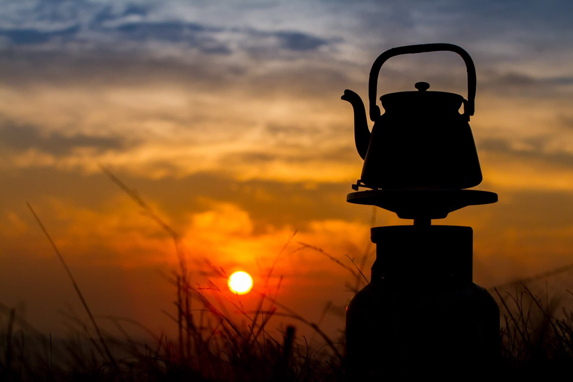 A kettle silhouetted against a Somerset sunset on the campsite