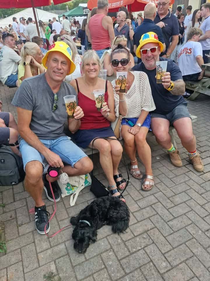 Regulars in party hats enjoying a festival day at the inn