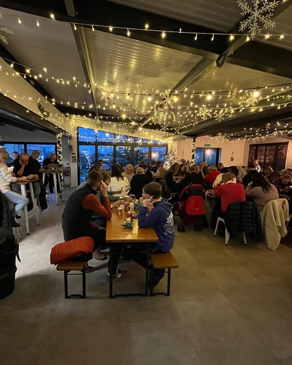 The Parlour café strung with fairy lights on a busy evening